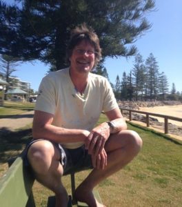 Mike Banks on a bench at Moffat Beach